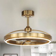 a ceiling light that is hanging from the ceiling in a room with white walls and flooring