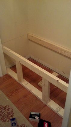 a wooden bench sitting on top of a hard wood floor