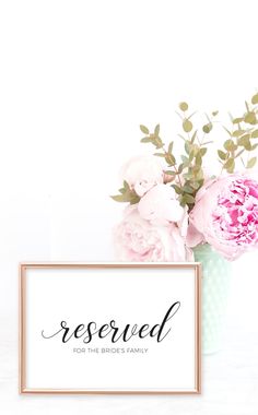 a vase filled with pink flowers next to a sign that says reserved for the bride's family