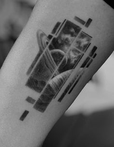 a black and white photo of a person's leg with a tattoo on it