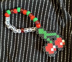 a close up of a person wearing a striped shirt with beads and bracelets on it