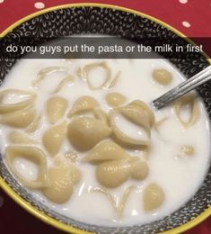 a bowl filled with milk and dumplings on top of a table