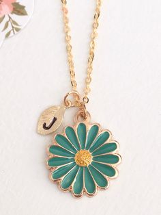 "Teal Flower Necklace, Gold Flower, Initial Flower Necklace, Anniversary Gift, Personalized Bridesmaid gift, Initial Necklace This dainty Teal Flower Necklace is plated in gold and enameled in Teal and Yellow. Personalized with tiny 16kt Gold plated leaf charm that is hand stamped with the initial of your choice. 18\" 16k Gold Plated Chain. ♥ Arrives in a gift box. ♥ With the hand stamped initial, this makes a thoughtful and personal gift. Thanks so much for stopping by. Feel free to contact me Flower Initial, Black Cat Necklace, Flower Necklace Gold, Daisy Pendant, Halloween Necklace, Teal Flowers, Lovers Necklace, Daisy Necklace, Personalized Bridesmaid Gifts