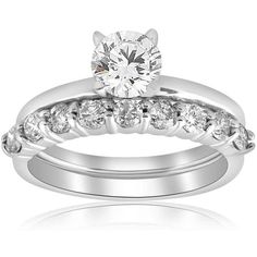 a white gold wedding ring set with diamonds on the side and an engagement band in front