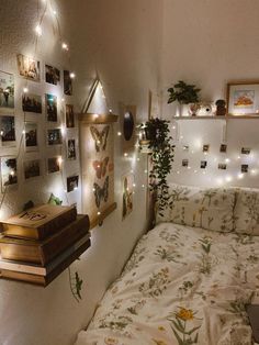 a bed room with a neatly made bed and lots of pictures on the wall