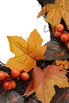 an arrangement of autumn leaves, berries and acorns