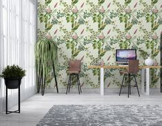 a room with two chairs and a desk in front of a wallpaper