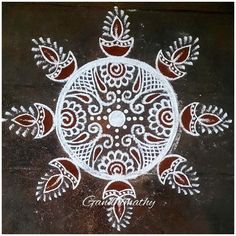 an intricate design on the ground in white and red