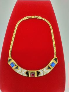 "This Art Deco/Modernist necklace is in Excellent dazzling condition, and is likely from the fashion-forward collection called \"Directives\" by Monet mid-80s. It is possible, too, that it was designed by YSL, as Monet was licensed to sell his designs during this period~~it certainly has the edgy glamour associated with YSL. It's absolutely stunning, featuring a gleaming golden snake chain suspending a curvy centerpiece with pave ice rhinestones, blue and red princess-cut crystals, and jet ename Leather Magazine Rack, Golden Snake, Red Princess, Vintage Runway, Enamel Necklaces, Black Enamel, Wedding Necklace, Snake Chain, Princess Cut