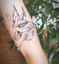 a tattoo on the arm of a person with a dog's head in it