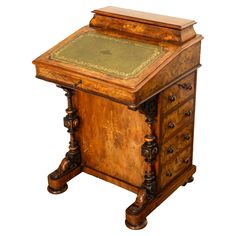 an antique wooden desk with green leather top