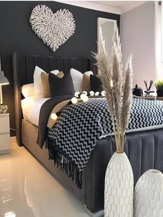 an instagramted photo of a bedroom with black and white decor