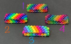 four different colored plastic beads are arranged in the shape of bracelets with numbers on them