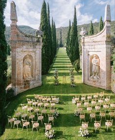 an outdoor ceremony setup with tables and chairs set up in front of the archways