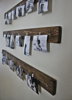 several photos hanging on clothes pins attached to a wall