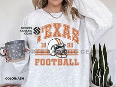 Show off your love and support for Texas football with this unisex crewneck sweatshirt 🏈.  This trendy, vintage style college football sweatshirt is pure comfort and is sure to become your new favorite for game days! ✨ FIT & STYLE ✨ This soft, cozy sweatshirt is a medium-heavy fabric. This runs true to size so size up for a more loose, oversized fit.  The collar is ribbed knit, so it retains its shape even after washing and there are no itchy side seams on these sweatshirts.  .: 50% cotton, 50% Texas Football, Sweatshirt Trendy, Gifts For Football Fans, Football Sweatshirt, Love And Support, Cozy Sweatshirts, Football Shirt, Dallas Cowboys, Football Shirts