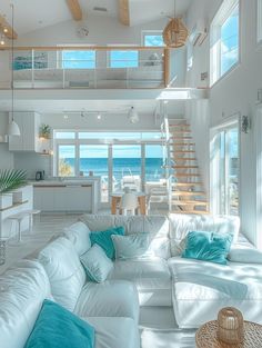 a living room filled with white furniture next to a kitchen and an open floor plan