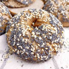 bagels with sesame seeds are sitting on a table