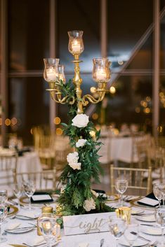 the centerpiece is decorated with white flowers and greenery