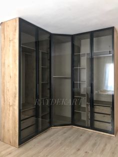 an empty room with glass doors and shelves