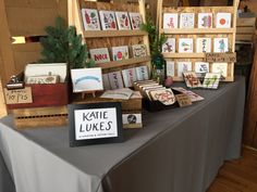 there are many cards on the table for sale at this market stall, including one with a sign that says kate lukees