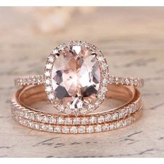 two rose gold wedding rings with an oval cut morganite surrounded by smaller round diamonds