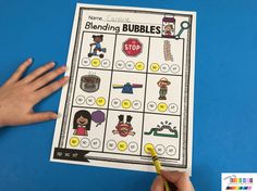 a hand is holding a pencil and pointing to a printable game for blending bubbles