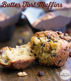 a muffin cut in half sitting on top of a wooden table