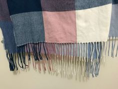 a multicolored blanket hanging on the wall