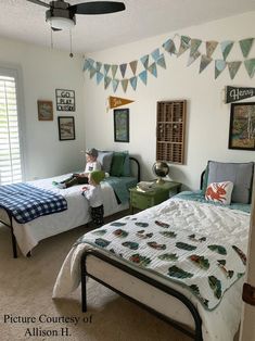 a bedroom with two beds and pictures on the wall