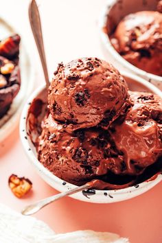 two bowls filled with chocolate ice cream on top of a table