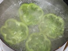 green peppers are being cooked in boiling water