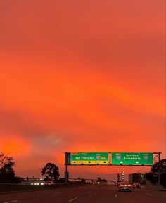 an orange sky is seen over the highway