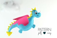 a blue and pink felt dragon flying through the air