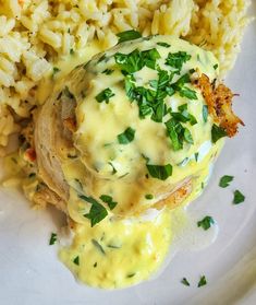 a white plate topped with rice and meat covered in gravy