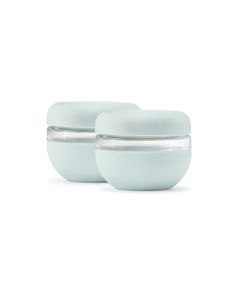 two white bowls with lids on each one are sitting side by side in front of a white background