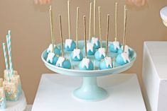 blue and white desserts on a cake plate with toothpicks in the shape of elephants