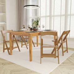 a dining room table and chairs in front of a window