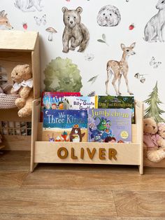 children's bookshelf in front of wallpaper with animals and forest scene