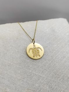 "Sea Turtle Necklace - Engraved Sea Life Charm - Gold Beach Charm - Gold Surfer Pendant ▪️ A beautiful and clean engraved Turtle pendant made out of 14K Solid Real Gold. Available only in yellow gold! Pendant Thickness: 0.50mm Jump Ring inner diameter: 4mm Dimensions - Small - 13x13mm / 0.51 x 0.51 inches Medium - 14x14mm / 0.55 x 0.55 inches Big - 15x15mm / 0.59 x 0.59 inches Necklace Length - You can choose your chain length from 35CM to 50CM. The pendant is available alone without a chain, se 14k Gold Etched Necklace For Gift, Laser Engraved Round Yellow Gold Necklace, Gold Laser Engraved Round Pendant Jewelry, Etched Yellow Gold Round Pendant, Laser Engraved Symbolic Round Jewelry, Gold Charm Necklace With Laser Engraved Round Pendant, Gold Round Laser Engraved Charm Necklaces, Ocean-inspired Gold Pendant Jewelry, Ocean-inspired Gold Pendant Necklace