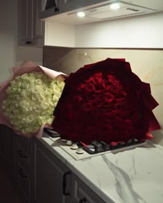 two bouquets of flowers sitting on top of a kitchen counter next to an oven