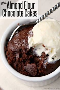 chocolate cake in a white bowl with ice cream on top and the words, mini almond flour chocolate cakes