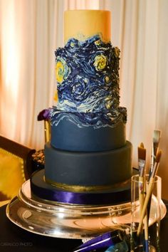 a three tiered cake decorated with the starry night theme