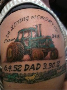 a man with a tractor tattoo on his arm