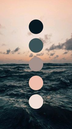 four circles floating over the ocean at sunset