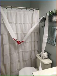 a bathroom with a shower curtain that has been pulled over and taped to the wall