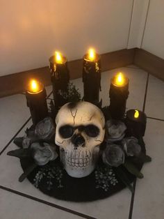 there is a skull with candles on the floor