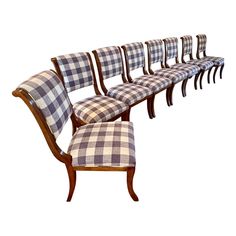 a set of six chairs with checkered upholstered back and arms, all lined up against each other