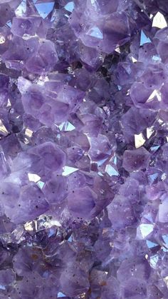 purple crystals are shown against a blue sky