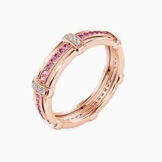 a rose gold ring with pink and white diamonds on the sides, set in 18k rose gold